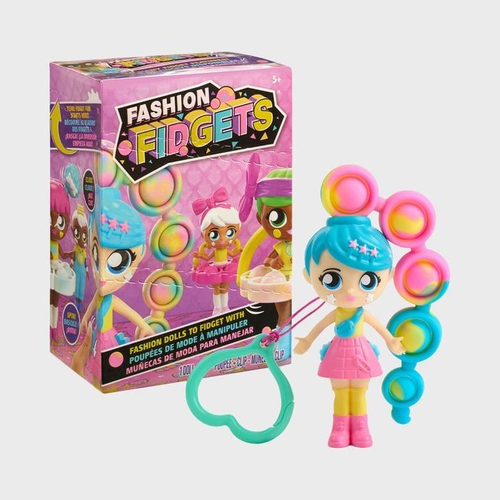 Doll with blue hair holds fidget toy, standing beside colorful 