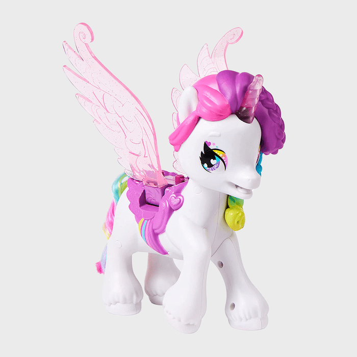 A winged unicorn toy stands, displaying colorful mane and tail, pink wings, and a saddle, set against a plain white background.
