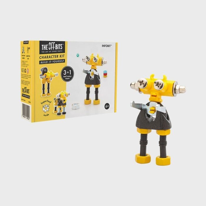 Robot figurine stands, assembled from bolts and metal, next to a colorful character kit box.