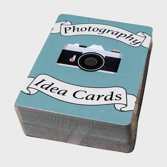 A stack of blue cards displays a vintage camera with text 