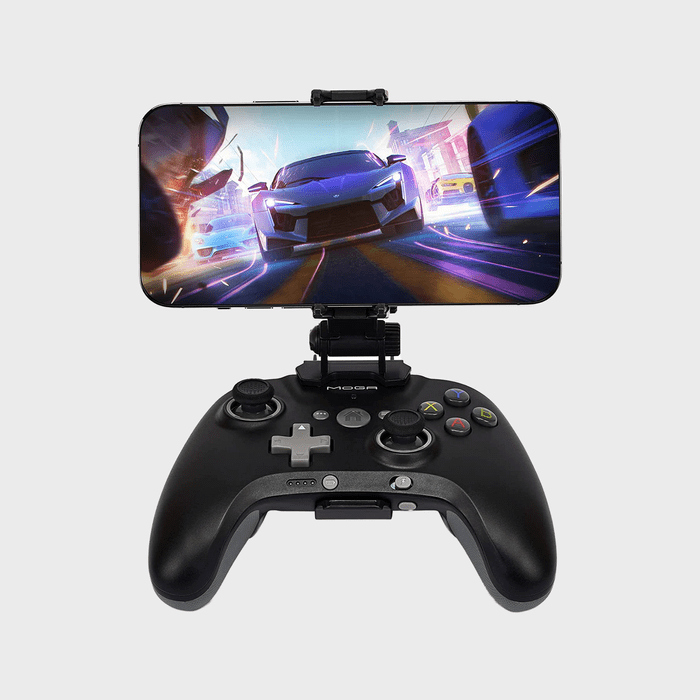 Game controller holds smartphone displaying racing game; colorful cars speed through vibrant city streets.