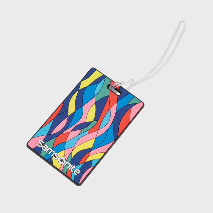 Tag displaying colorful abstract patterns, attached to a white strap, with the word 