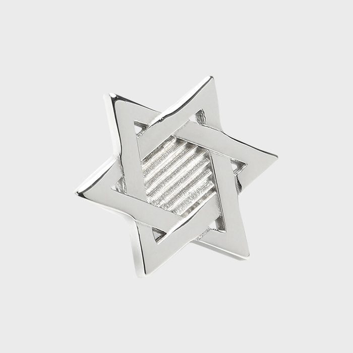 A silver Star of David rests on a plain grey background.