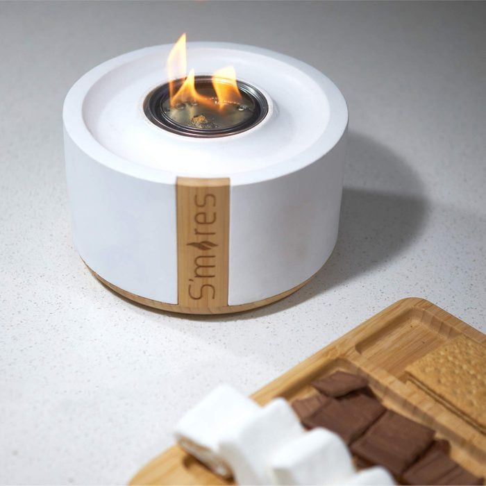 A small tabletop fire pit with flames, labeled 