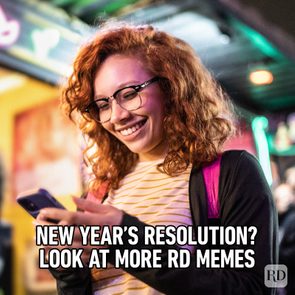 Woman smiling, looking at phone; colorful indoor setting. Text reads, 
