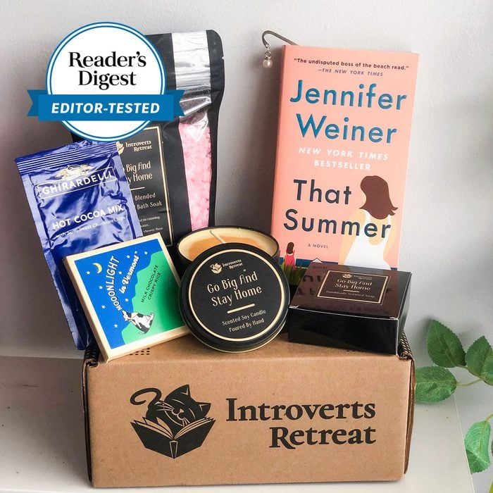 Box holds book, candle, and snacks. Book titled 