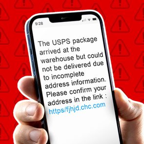 Hand holds a phone displaying a message about a USPS package delivery issue, with a suspicious confirmation link, against a red warning backdrop.