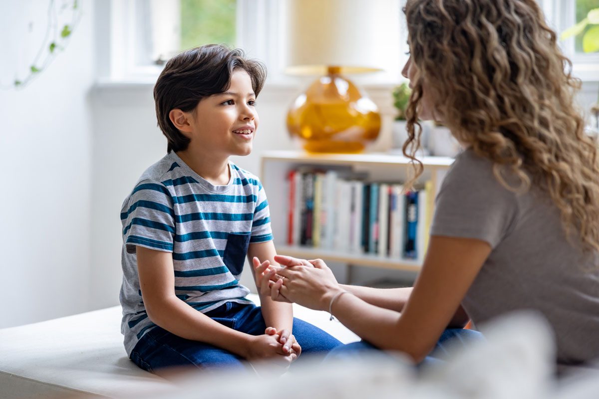 Boy Talking To Her Mother At Home