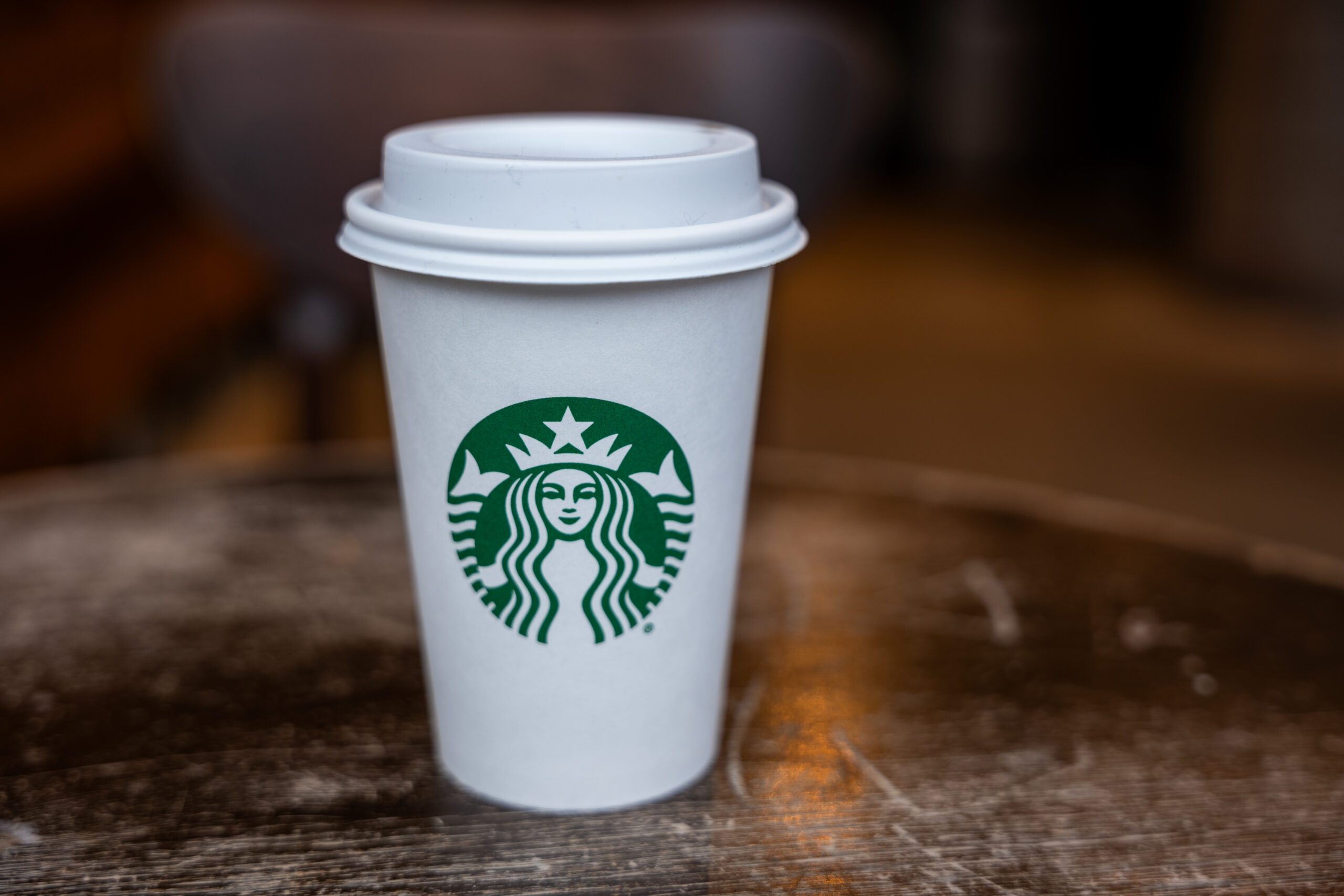 Starbucks white hot coffee cup on a wooden table