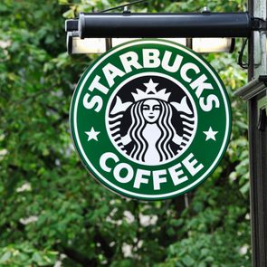 Starbucks coffee sign hanging outside a shop