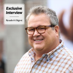 Headshot of Eric Stonestreet, wearing glasses and smiling, with 