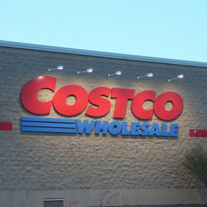 Costco Wholesale logo lit up on the exterior of a Costco building