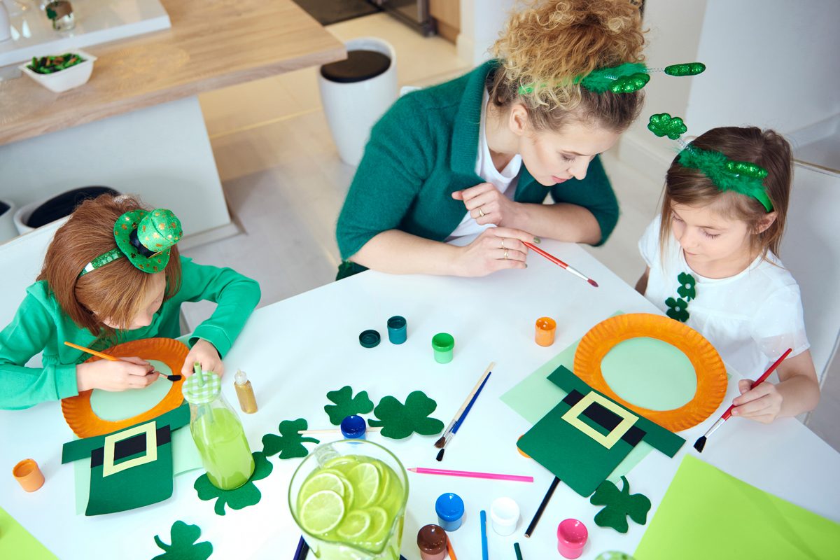 Mother With Children Making Decorations For Saint Patricks Day