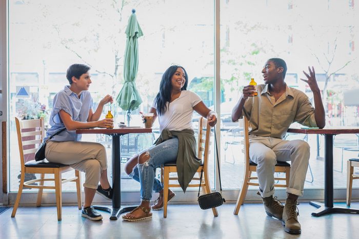 friends in casual clothes talking in a restaurant