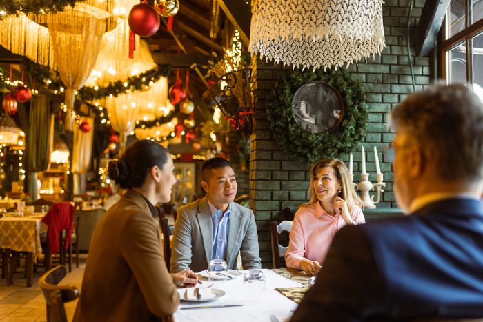 group of people eating in a restaurant on christmas