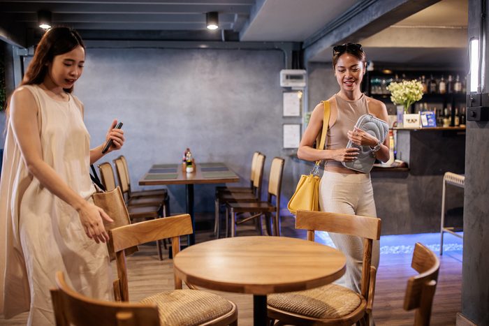 women arriving at their table at a restaurant