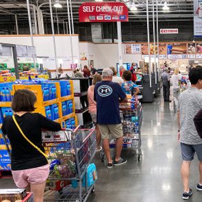 Shoppers wait in a check-out line at a Costco