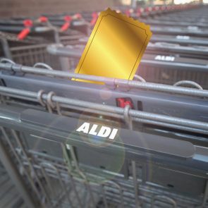Aldi shopping cart with a shining golden ticket sticking out of it