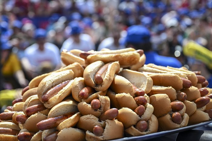 pile of hot dogs at an eating contest