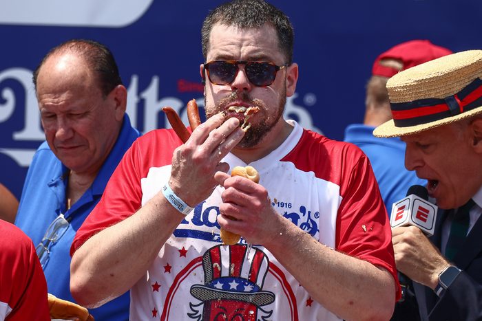 man eating hot dogs at an eating contest