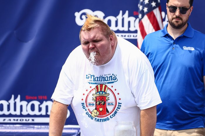 man puking at an eating contest