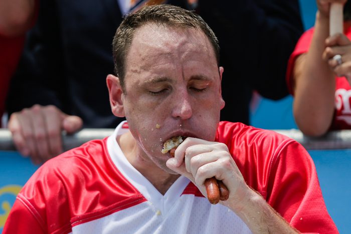 joey chestnut eating hot dog at an eating contest