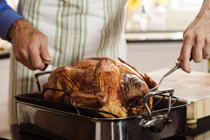 man carving turkey