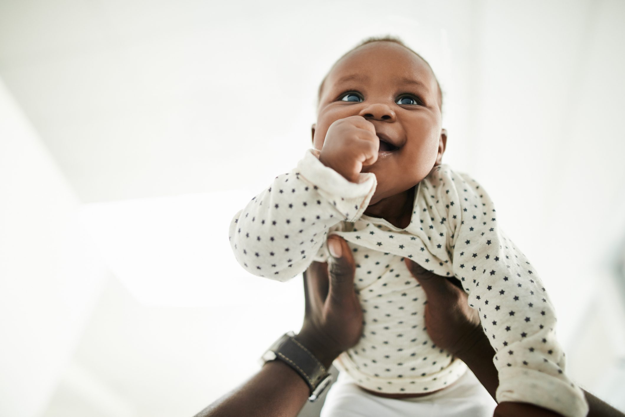 Baby being held up