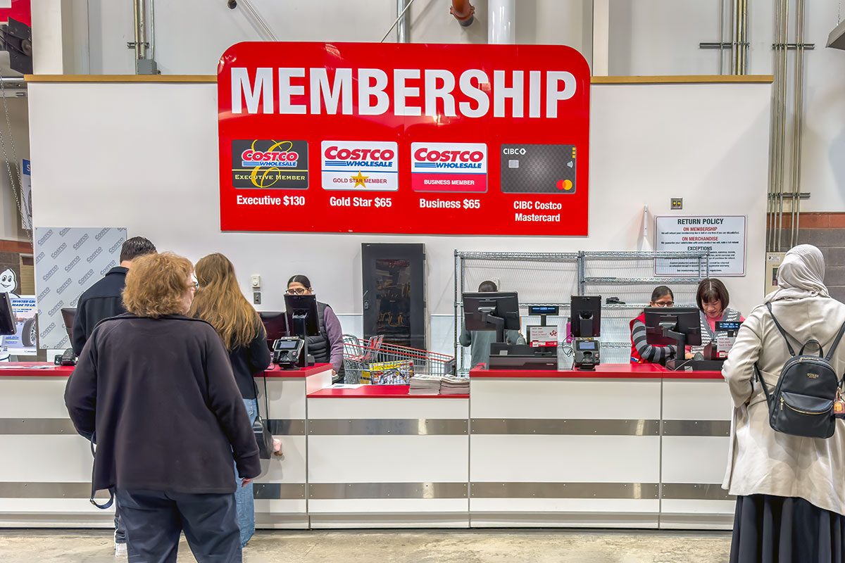 A Costco membership counter where customers are being assisted by employees