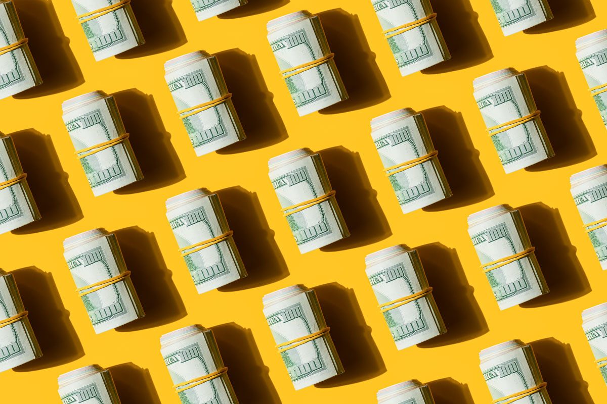 Mosaic Pattern Of American Dollar Banknotes Bills On The Yellow Background