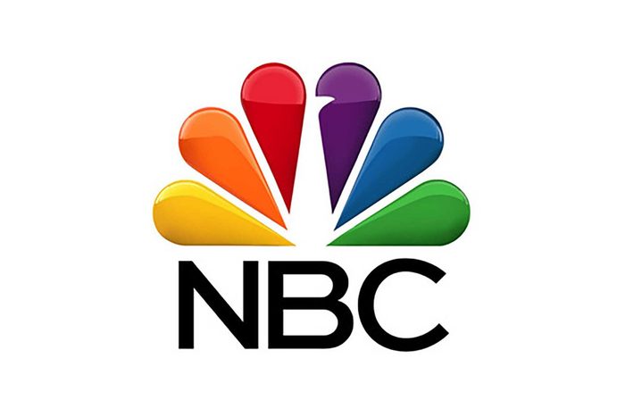 Multicolored peacock feathers fan outward above text "NBC," set against a white background.
