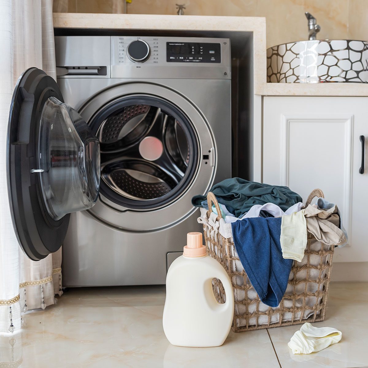 Basket with laundry and washing machine