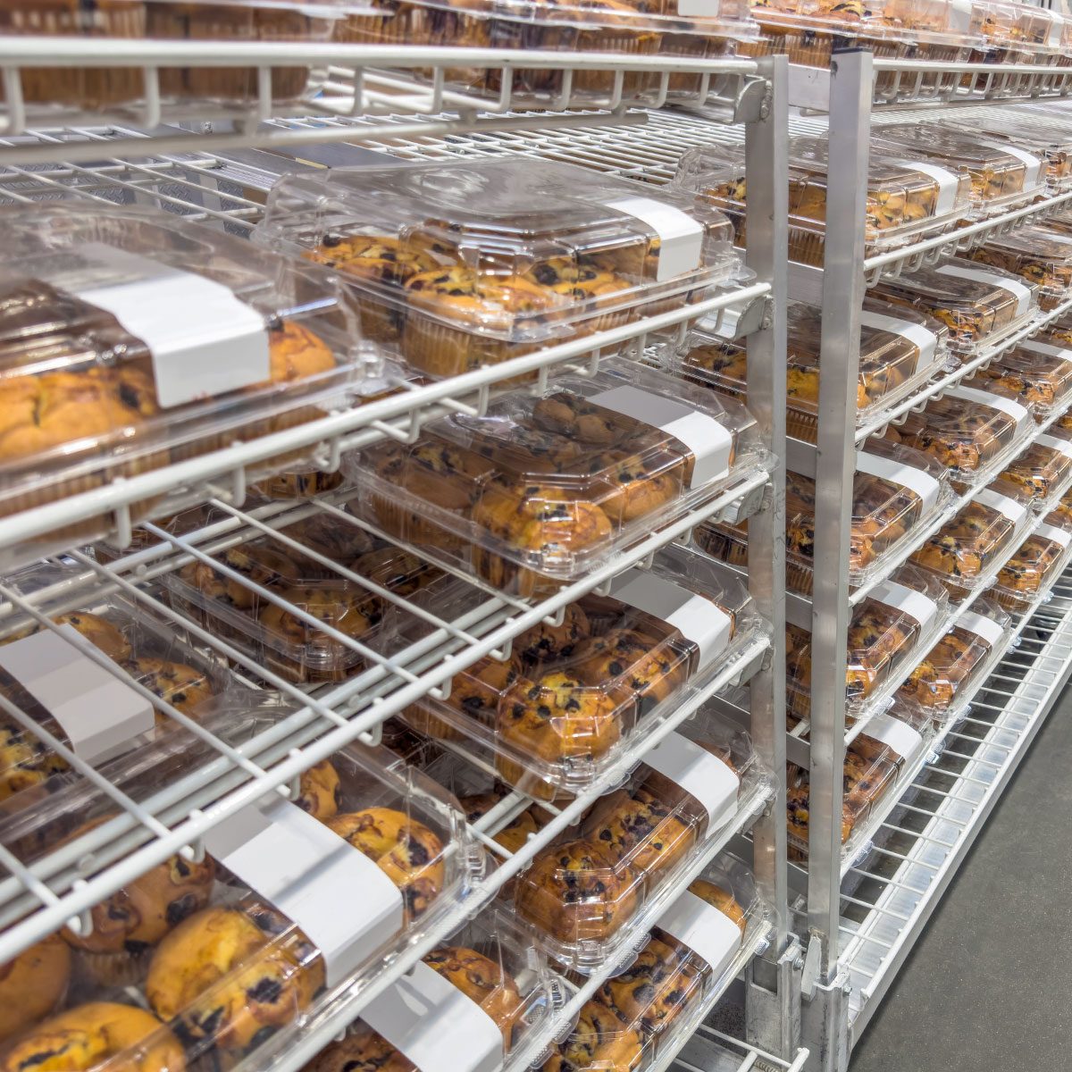 Freshly croissants and muffins in a bakery section of a supermarket