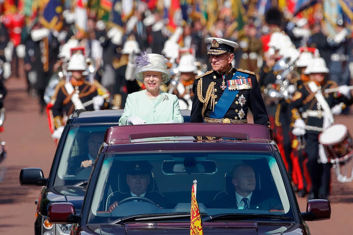 ueen Elizabeth II and Prince Philip, Duke of Edinburgh travel down The Mall in the open-topped State Review Range Rover