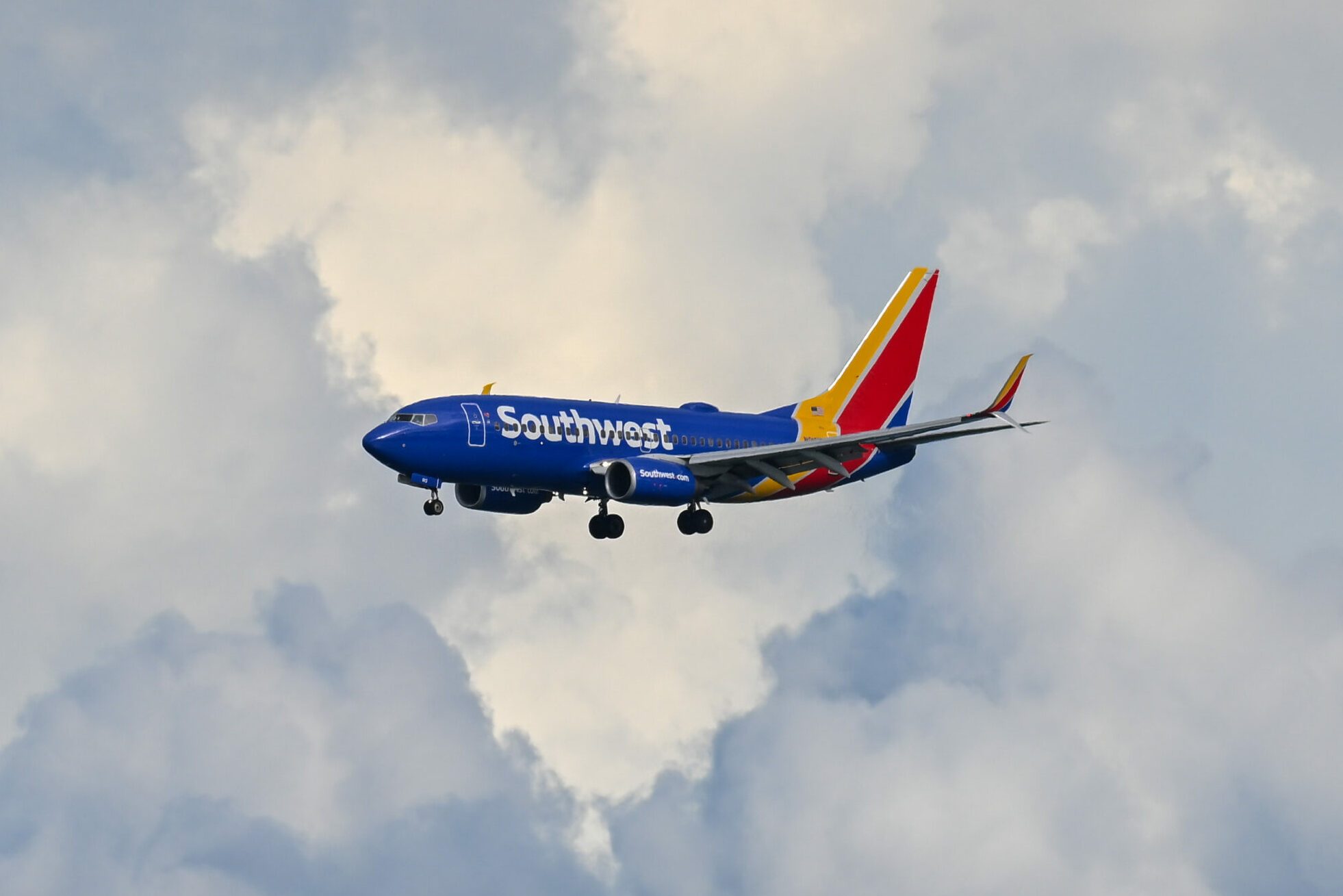 Southwest Plane in the sky with clouds in the background