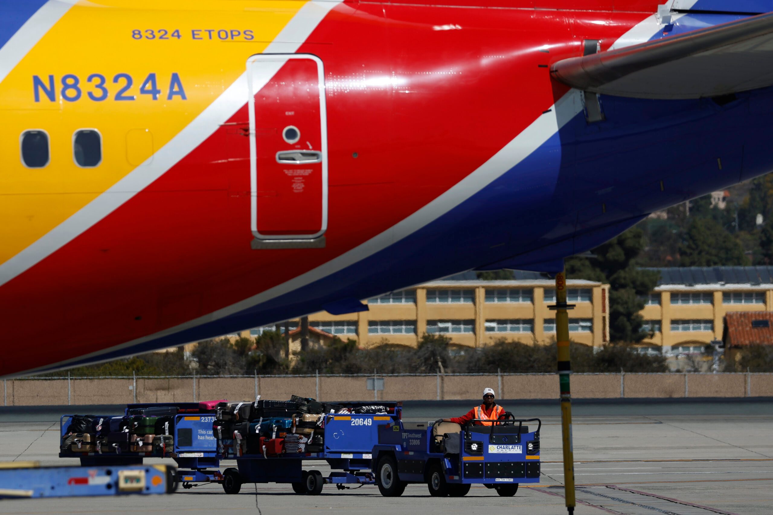 Baggage trolley bringing luggage to a Southwest planee