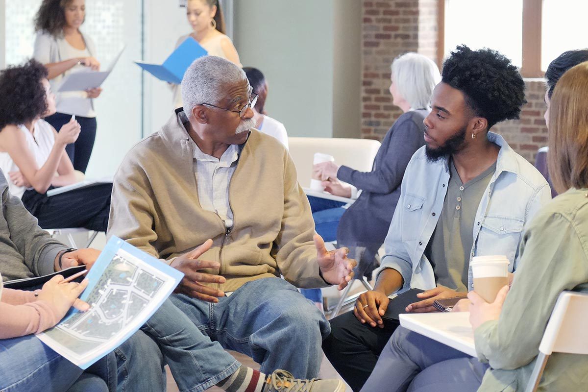 A multi-ethnic, multi generational group openly discusses the racial issues dividing their community.